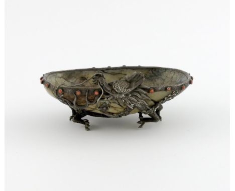 A Chinese silver-mounted jade dish, unmarked, the carved jade bowl mounted with a dragon, on four claw feet, the border with 
