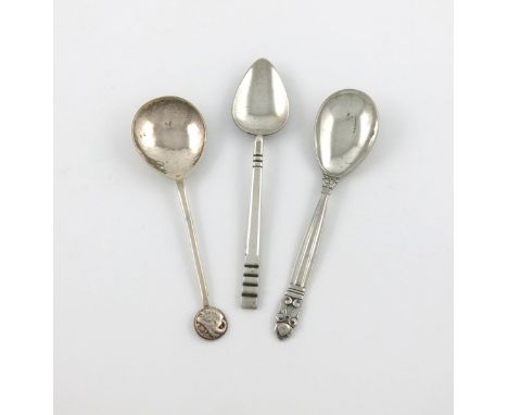 By The Artificer's Guild, an Arts and Crafts silver spoon, London 1933, fig shaped bowl, spot-hammered decoration, with a ram