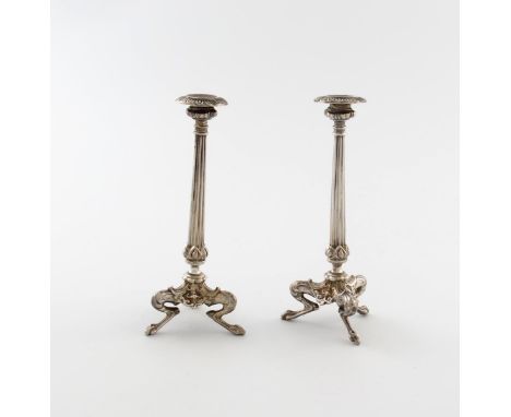 A pair of Victorian silver taper sticks, by Henry Wilkinson and Son, Sheffield 1848, tapering fluted columns, on three squat 