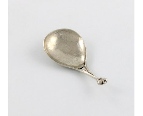 By Liberty and Co, an Edwardian Art Nouveau silver caddy spoon, Birmingham 1904, also stamped CYMRIC, spot hammered decoratio