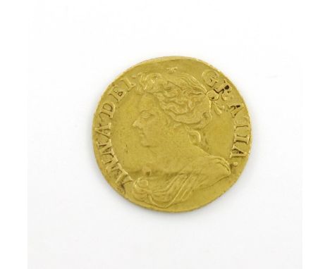 Queen Anne, Gold Guinea, 1714 (S. 3574). Nearly fine, but has been mounted, gilt and creased. Newspaper cutting states "found