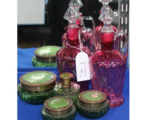 PAIR OF CRANBERRY GLASS DECANTERS
with clear glass handles and stopper; together with four green glass and enamel dressing ta