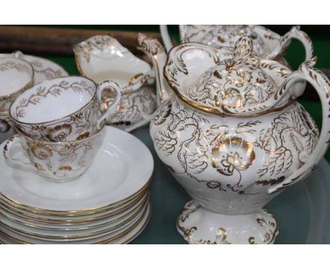 19TH CENTURY CENTURY TEA SERVICE
each decorated with stylised floral and foliate linear motifs in gilt on an ivory ground, un