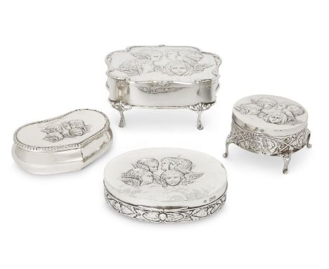 Four Victorian and Edwardian silver trinket boxes, the lid of each decorated with winged putti, the group comprising an examp