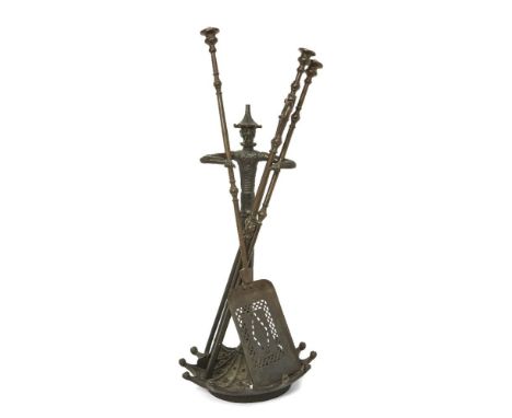 An English cast-iron fire-tool stand, early 20th century, modelled as Chinese figure with out-stretched arms, the base as an 