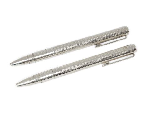 A cased pair of silver ballpoint pens, London, 2014, SJ, of engine turned design, 13.5cm longPlease refer to department for c