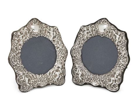 A matched pair of silver mounted photo frames, London, 1981 and 1989, Keyford Frames and D.R&S., the foliate scroll borders d