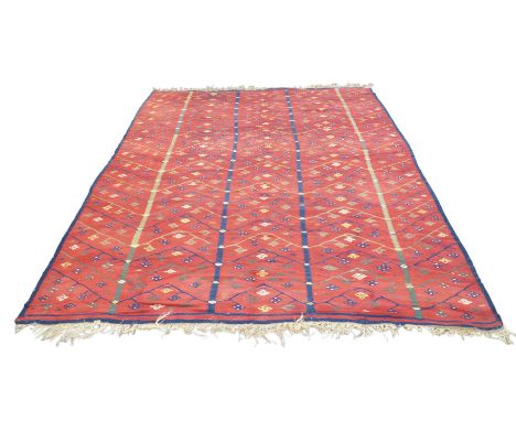 An Azari Kilim carpet, North West Persian, early 20th century, with green and blue geometric design, on a rouge ground, 356 x