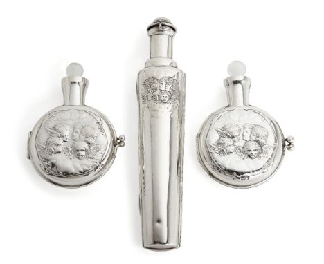 Two Victorian putti-decorated silver cased scent bottles by William Comyns, London, 1898 and 1899, 12.6cm long, together with