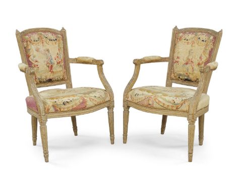 A pair of French fauteuil, late 19th century, with stud bound tapestry upholstery, reeded frame, raised on fluted supportsPle