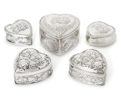 Five heart-shaped Victorian and Edwardian silver trinket boxes variously decorated with putti, the largest example Chester, 1