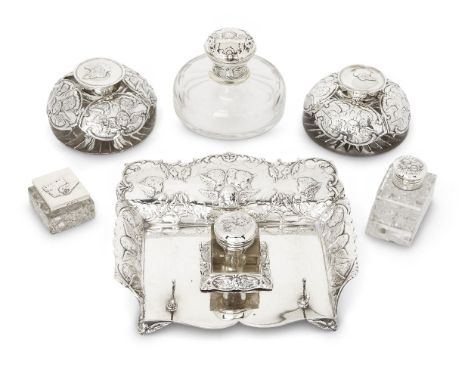 Six various putti-decorated silver mounted inkwells, including one with silver inkstand, the group comprising: a silver mount