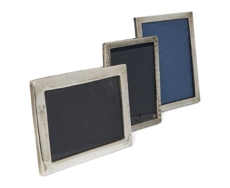 Three rectangular silver mounted photo frames, each with easel back, the largest example designed with plain silver border, B