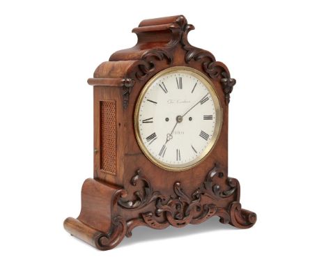 A Victorian walnut eight day mantel clock, late 19th century, the walnut case with relief carved scrolling foliate decoration