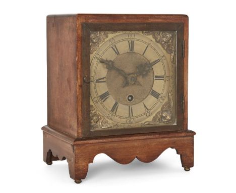 A mahogany mantel timepiece, circa 1900, the square mahogany case on bracket support with shaped apron, the brass dial with c