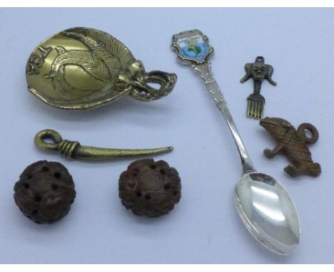 Two carved netsukes, three metal African pendants, an Australian brass caddy spoon and a silver collectors spoon, Melbourne O