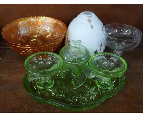 A carnival glass bowl, an etched glass footed dish, a glass light shade and a dressing table set