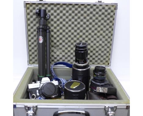 A Minolta SRT101 camera with three lenses, wide angle, telephoto and a standard lens and tripod, in a Hakuba camera case