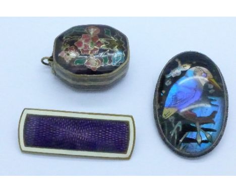 A silver mounted butterfly wing brooch, an enamel brooch and an enamel pill box