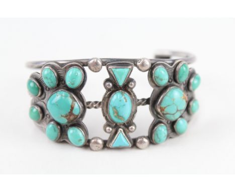 A silver Native American turquoise set bangle (60g) 