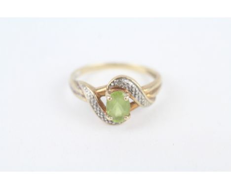 9ct gold peridot single stone ring with diamond frame 