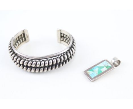 A silver Native American made bangle and pendant (82g) 