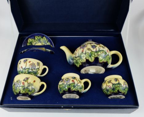 Moorcroft tea set in the hepatica design comprising teapot, sugar bowl, milk jug and two cups and saucers, in presentation bo