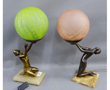 Two Art Deco style figural table lamp bases, one with green glass shade the other with pink glass shade, (2) 
