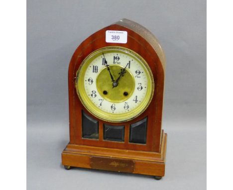 Mahogany cased mantle clock with arched top over circular dial with Arabic numerals to the chapter ring, 30cm high 