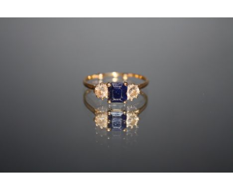 A THREE STONE SAPPHIRE AND DIAMOND RING, set in unmarked yellow metal, each diamond being an estimated quarter carat, ring si