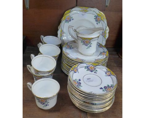 A Wetley china Art Deco enamelled decoration tea set, some a/f, 12 tea plates, saucers, 7 cups, milk jug and two sandwich pla