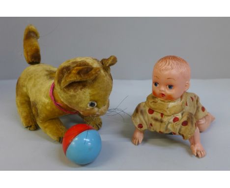 A vintage clockwork kitten, one eye missing and clockwork baby toy 