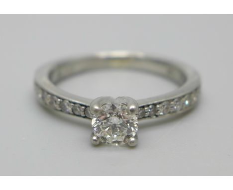 A platinum ring set with a central diamond and 16 smaller diamonds to the shoulders, 5.2g, M 