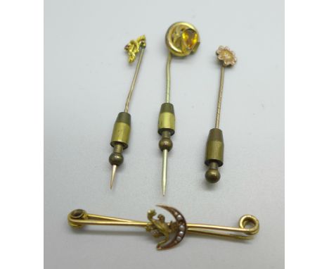 Two 15ct gold topped stick pins, a metal stick pin and a bar brooch with later added decoration 