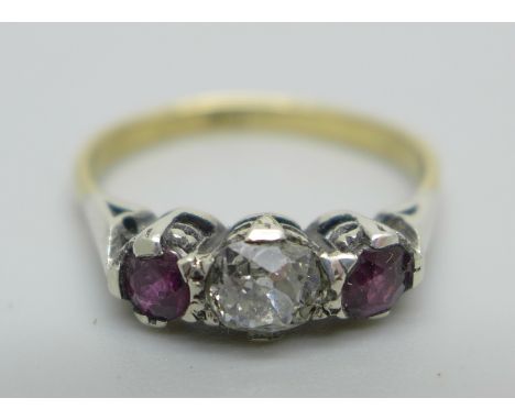 A yellow metal ring set with two rubies and a central old cut diamond, stamped 18ct, 2.1g, O, in a vintage ring box 