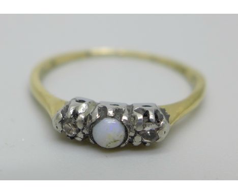 An 18ct and platinum ring set with a central opal and two diamonds, 1.8g, O 