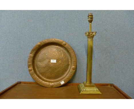 A brass Corinthian column table lamp and an Arts and Crafts copper tray 