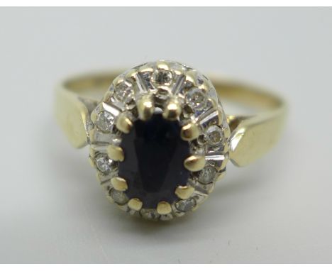 A 9ct gold cluster ring set with a central sapphire and diamond halo, 2.1g, L 