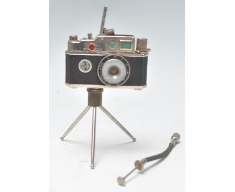 A vintage novelty Photolite Oriental cigarette lighter in the form of a miniature camera complete with miniature tripod and s
