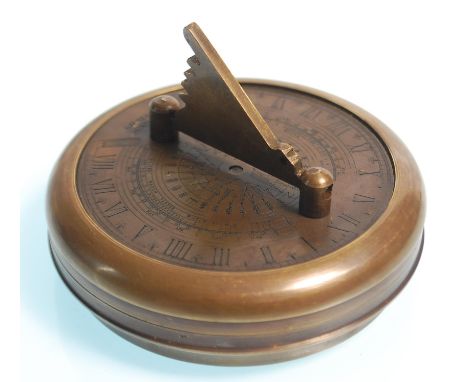 A brass cased Gilbert pocket sundial and compass, the round case opening to reveal the compass with a folding sundial to the 