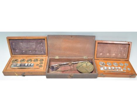 An early 20th Century mahogany cased set of&nbsp;portable brass scales together with two cased sets of weights. One brass exa