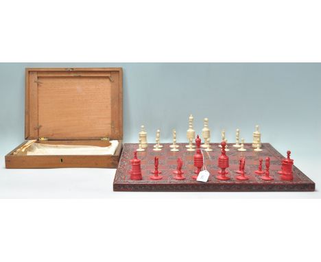 A superb 19th Century Victorian English bone and red stained first edition chess set with turned pieces. Complete set togethe