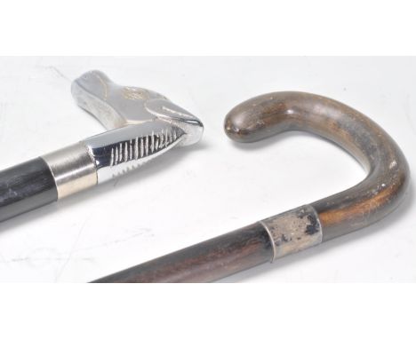 A contemporary walking stick cane having a white metal horse head handle and ebonised tapering shaft with hidden drinking fla