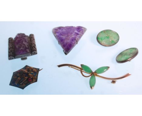 A collection of jade and amethyst jewellery to include two Chinese carved amethyst lapel brooches each decorated with carved 