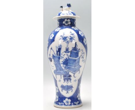 A 19th Century blue and white lidded vase being hand painted in the prunus pattern with a central panel decorated with the pr