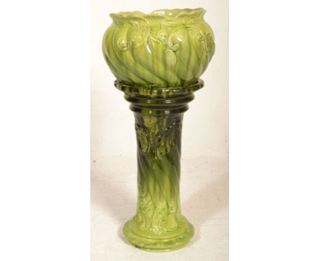 A 19th century / 20th century majolica planter in a two tone green colourway. Raised on shaped Art Nouveau plinth base and pl