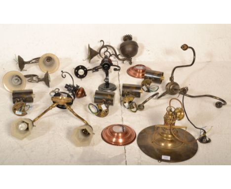 A collection of brass lights and fittings to include oil lamp style, twin sconce wall light, factory / industrial brass penda