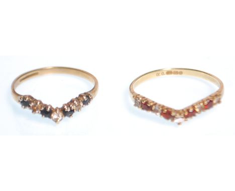 Two hallmarked 9ct gold wishbone rings, one set with alternate blue and white stones (size K.5), the other with alternate red