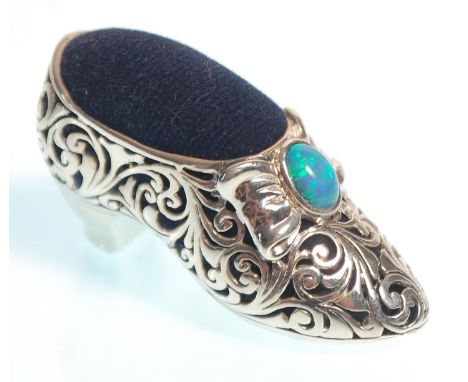 A stamped 925 silver pin cushion in the form of a shoe having pierced decoration&nbsp; and set with an opal, having a blue ve
