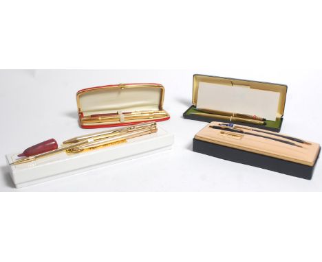 A good mixed collection of pens to include a two pen boxed Cross pen set and another boxed example both in a gold tone colour
